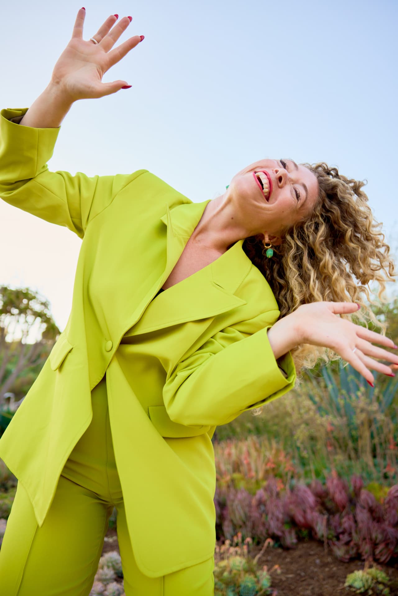 Rachel Frank laughing in a lime green suit